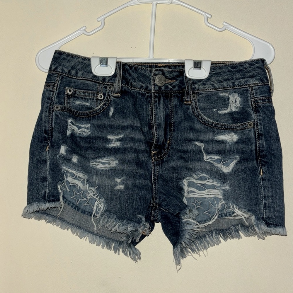 baggy blue jean shorts with stars on the pockets